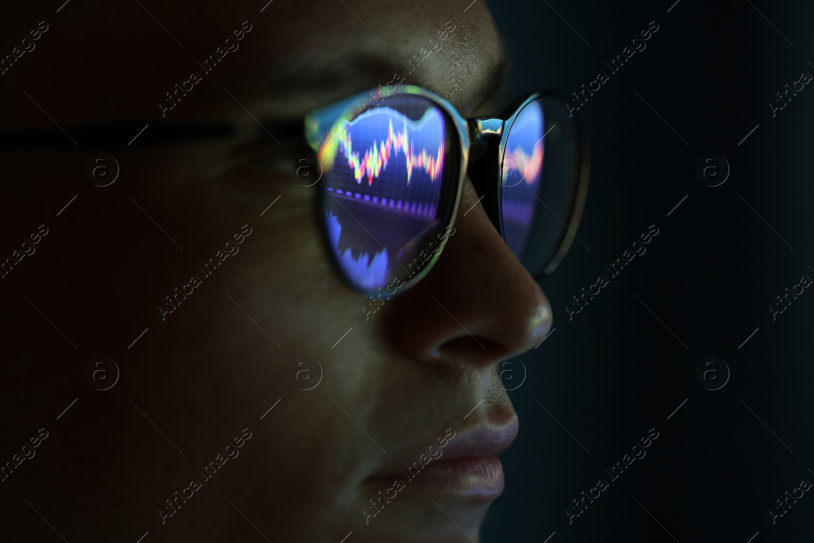 Young man wearing glasses with reflection on dark background, closeup Photo of Young man wearing glasses with reflection on dark background, closeup