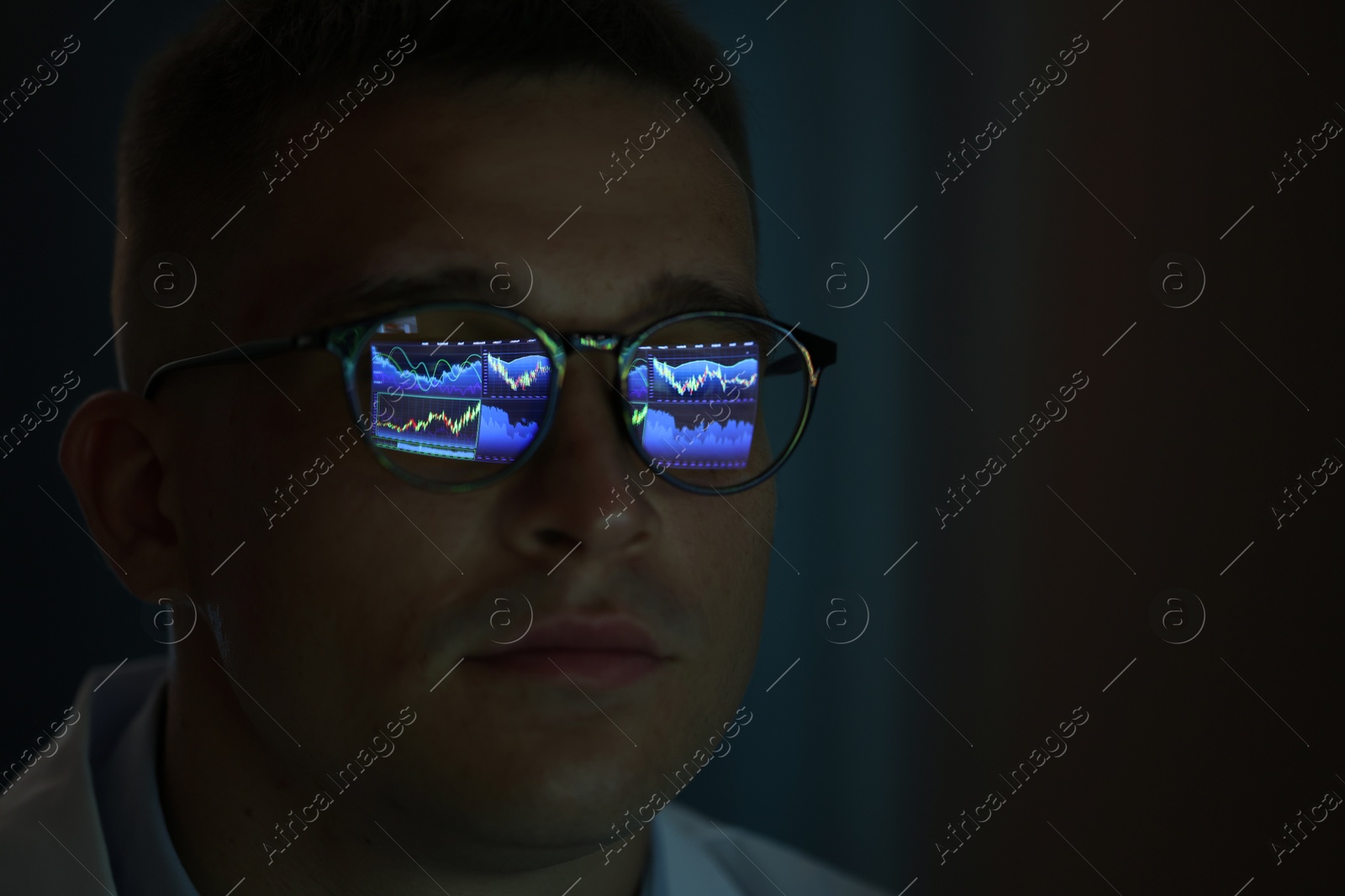 Young man wearing glasses with reflection on dark background, closeup Photo of Young man wearing glasses with reflection on dark background, closeup