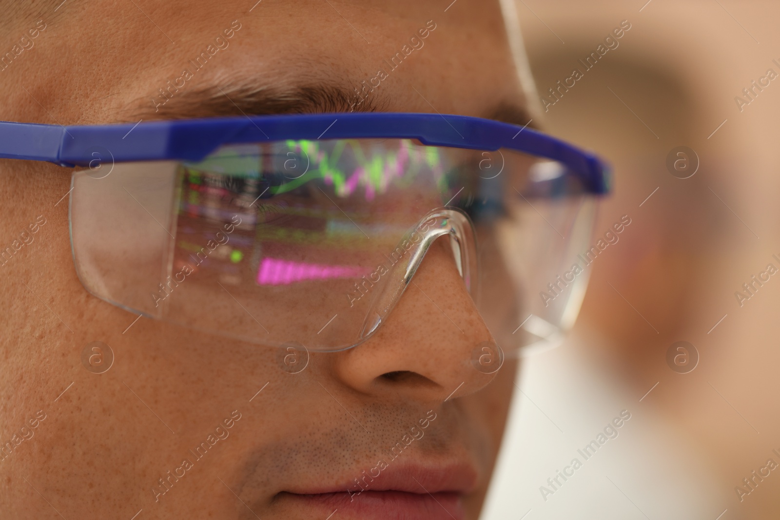 Young man wearing glasses with reflection on blurred background, closeup Photo of Young man wearing glasses with reflection on blurred background, closeup