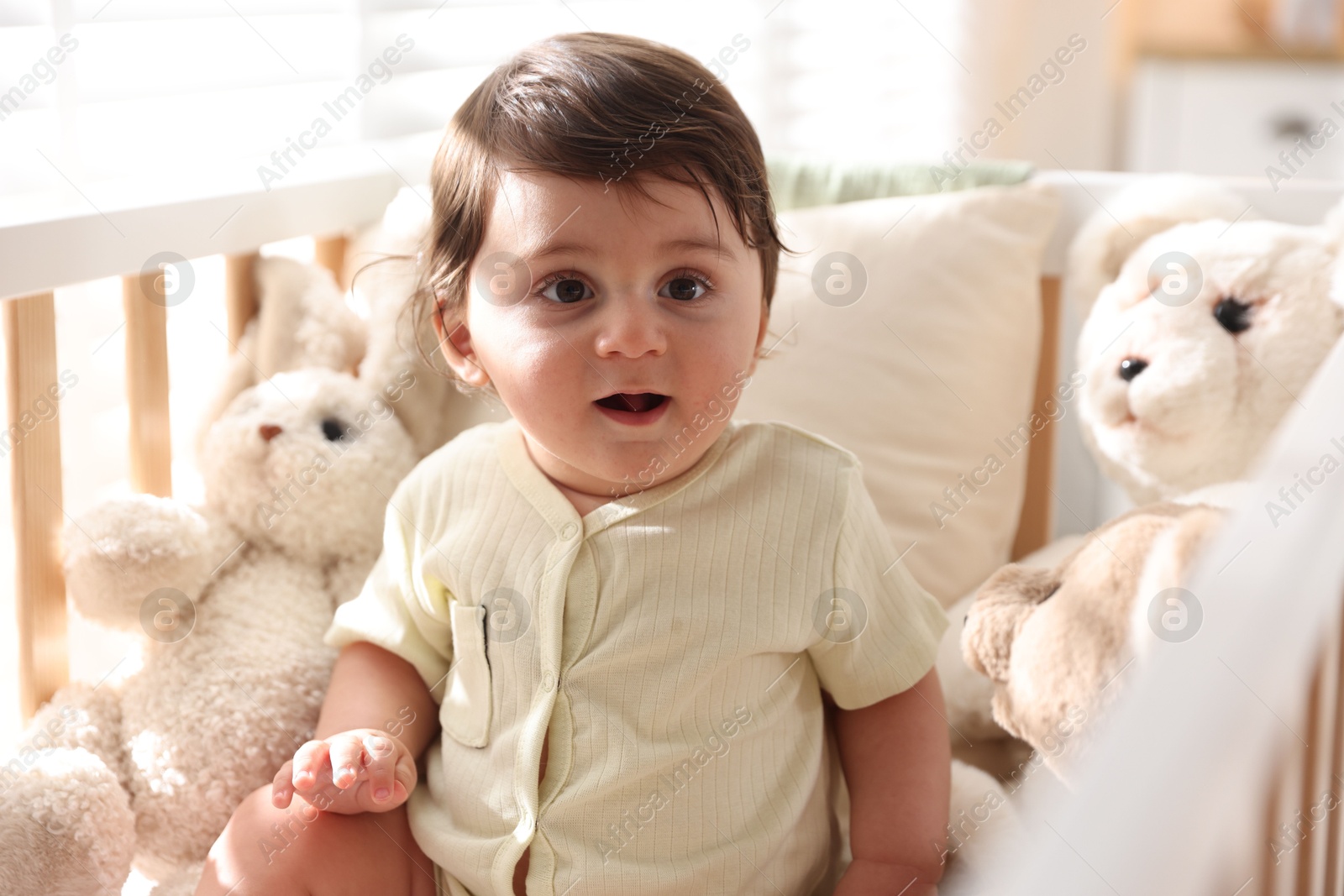 Photo of Cute little baby in crib at home