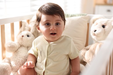 Photo of Cute little baby in crib at home