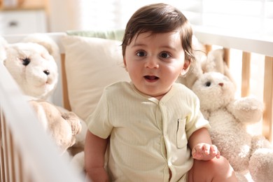 Photo of Cute little baby in crib at home