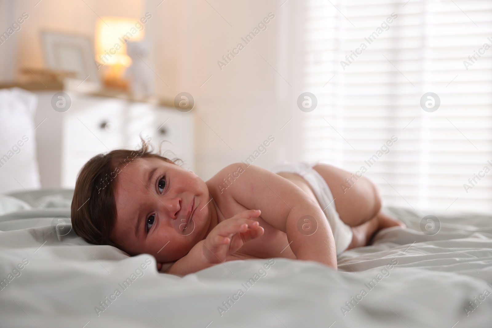 Photo of Cute little baby on bed at home