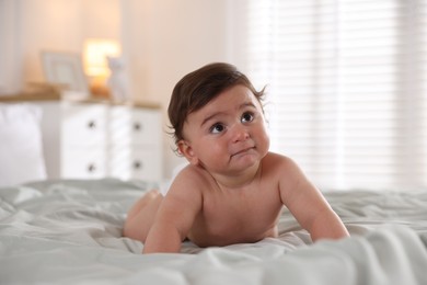 Photo of Cute little baby on bed at home