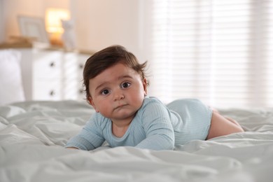 Photo of Cute little baby on bed at home