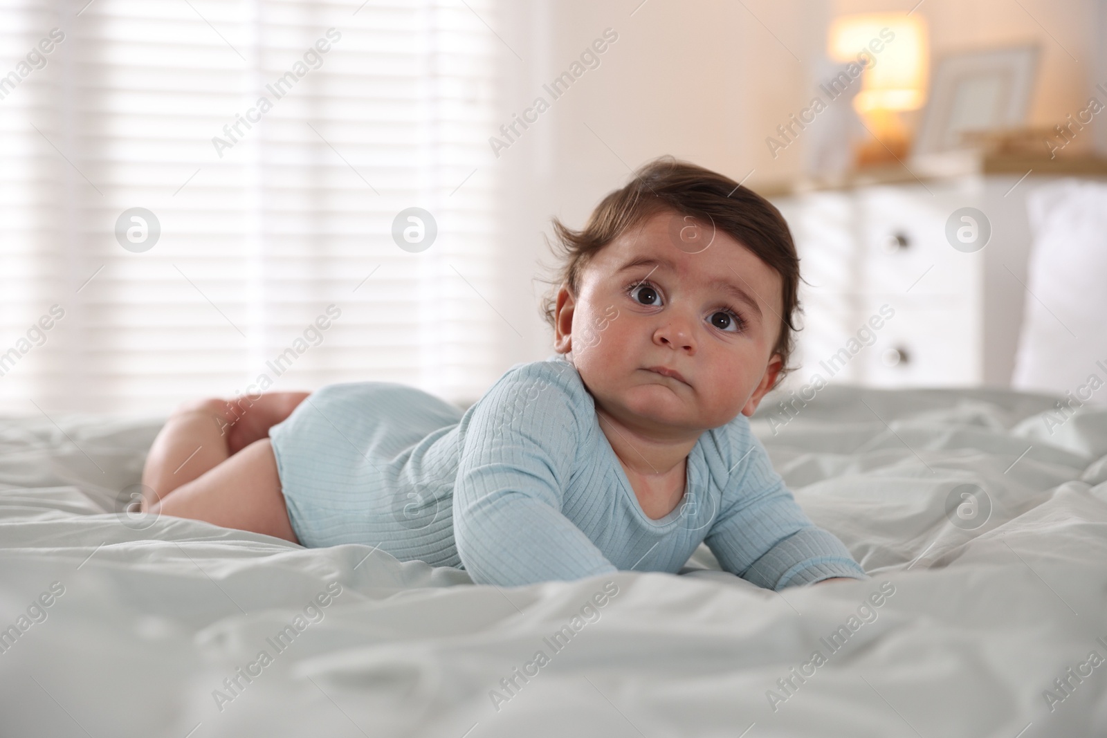 Photo of Cute little baby on bed at home