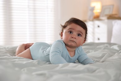 Photo of Cute little baby on bed at home