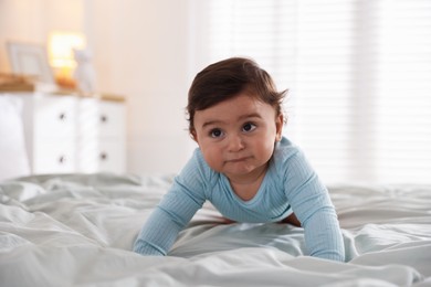 Photo of Cute little baby on bed at home