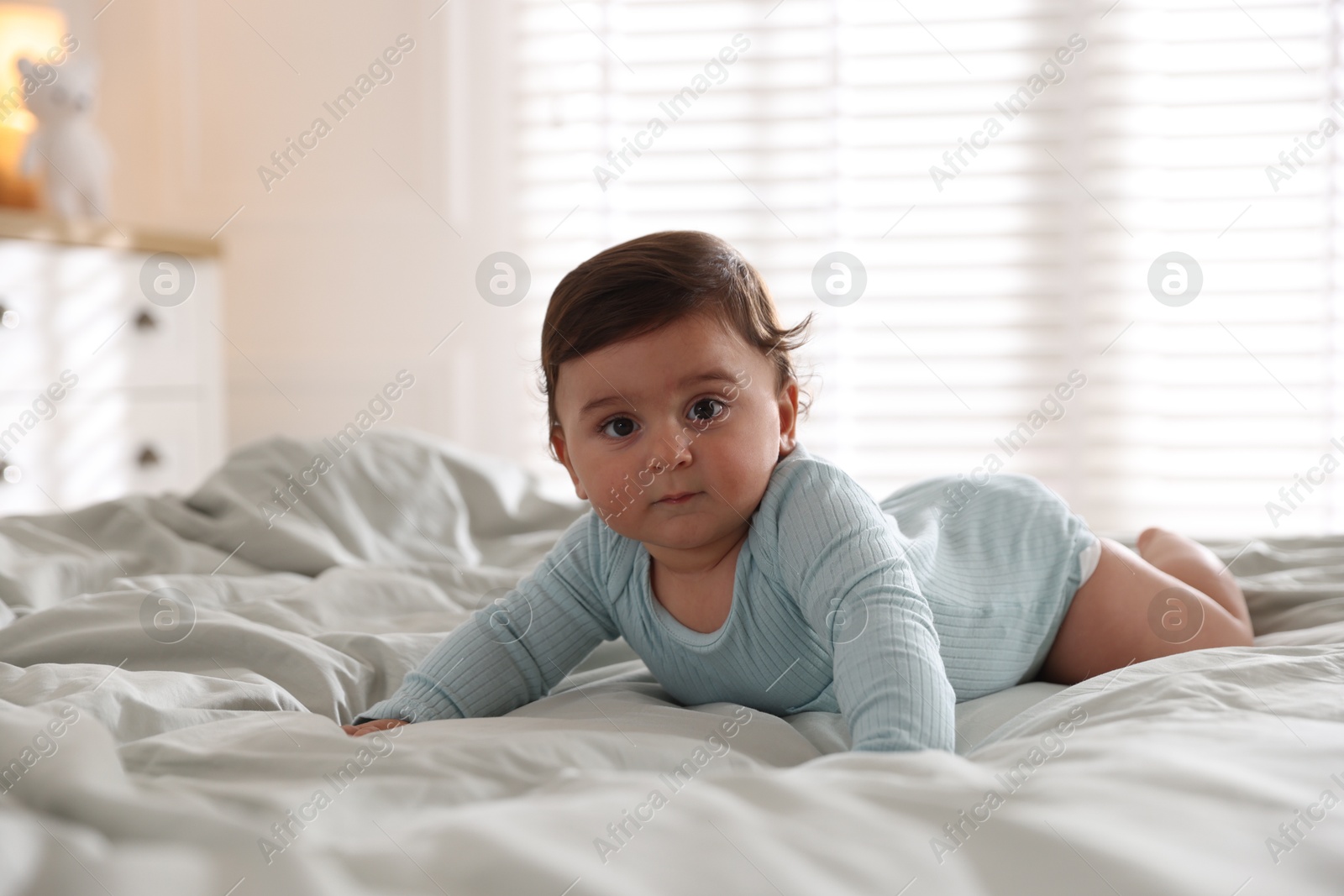Photo of Cute little baby on bed at home