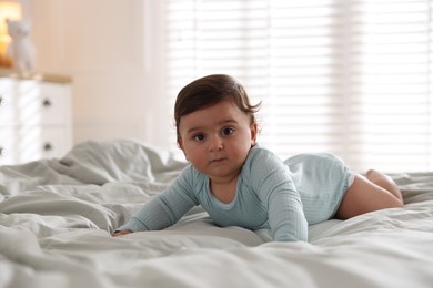 Photo of Cute little baby on bed at home