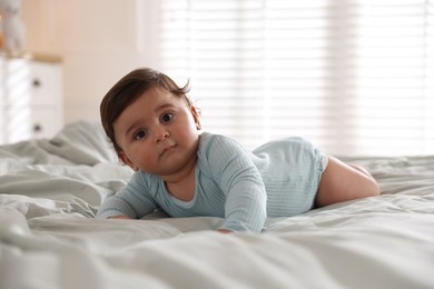 Photo of Cute little baby on bed at home