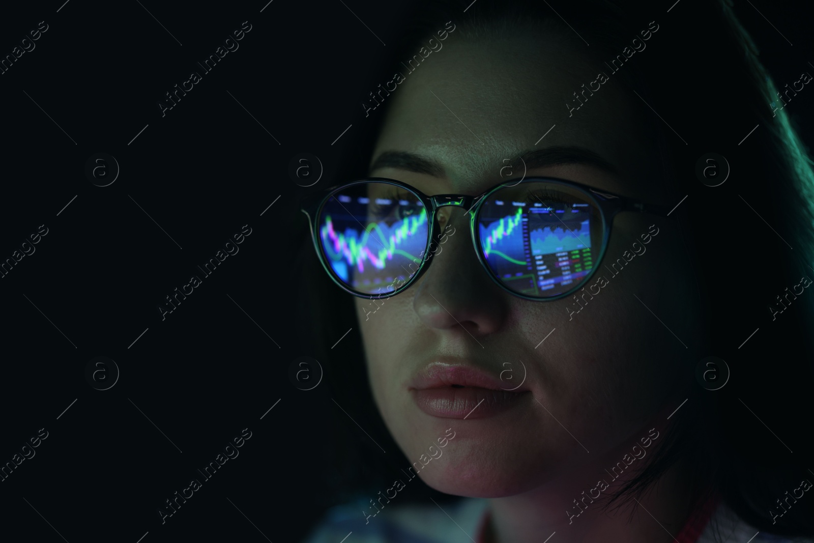 Young woman wearing glasses with reflection on dark background, closeup Photo of Young woman wearing glasses with reflection on dark background, closeup