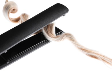Photo of Straightener with blonde hair lock isolated on white