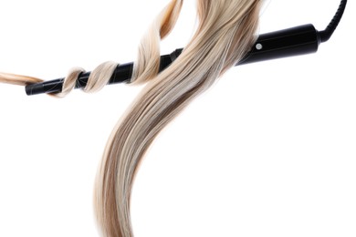 Photo of Curling iron with blonde hair lock isolated on white