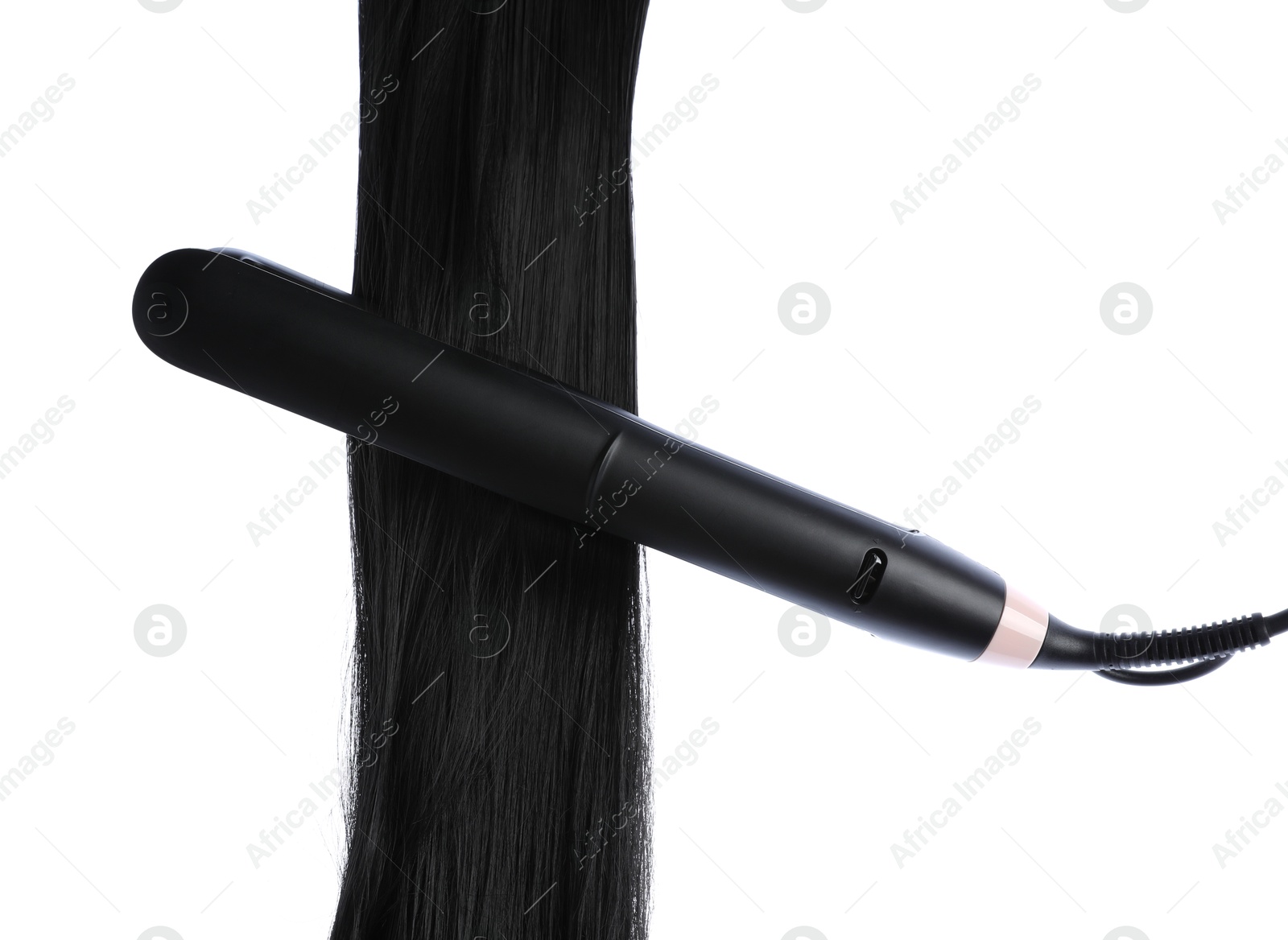 Straightener with black hair lock isolated on white Photo of Straightener with black hair lock isolated on white