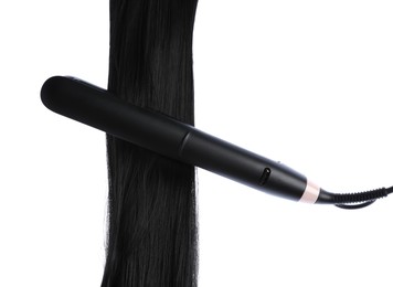 Photo of Straightener with black hair lock isolated on white