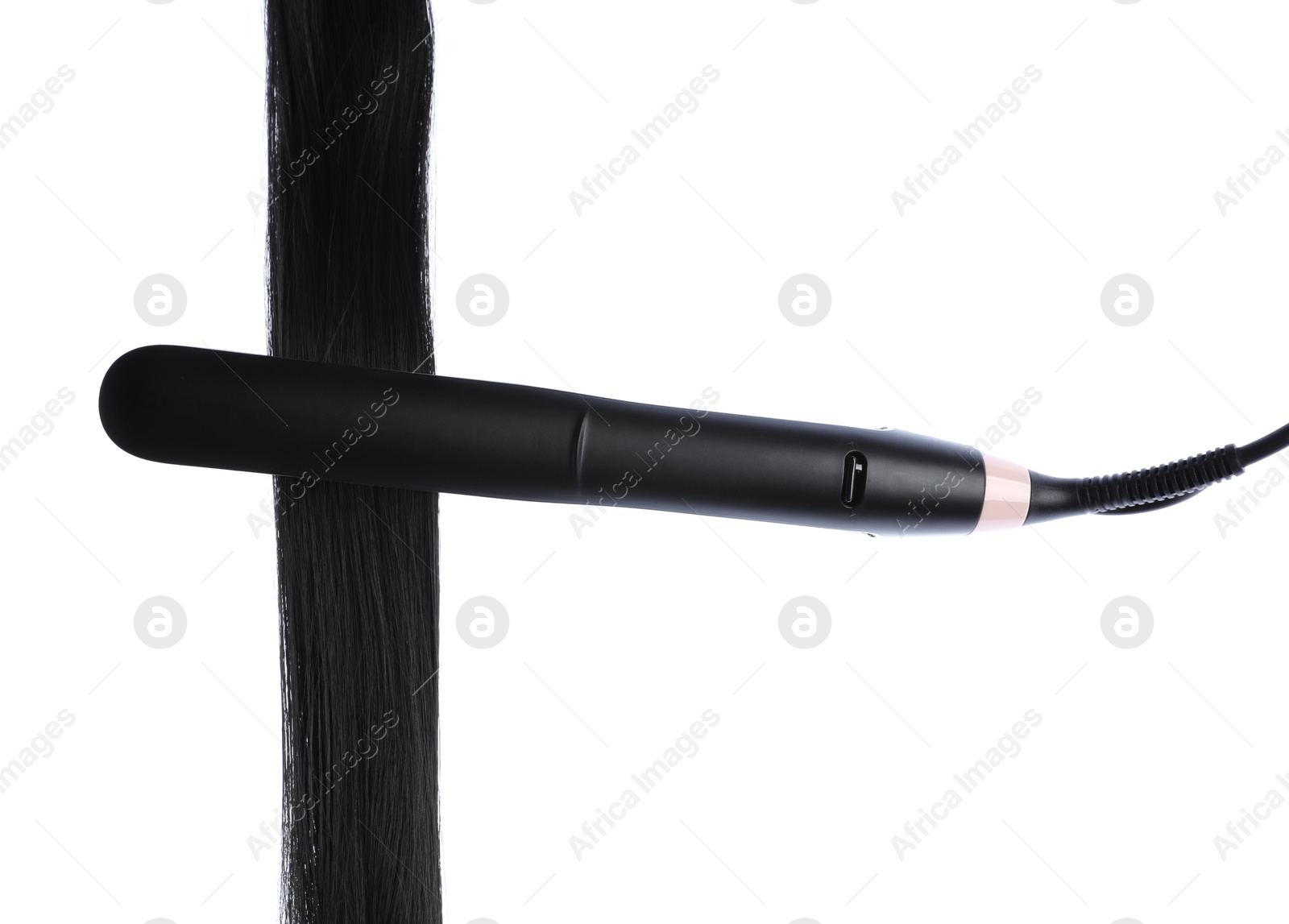 Straightener with black hair lock isolated on white Photo of Straightener with black hair lock isolated on white