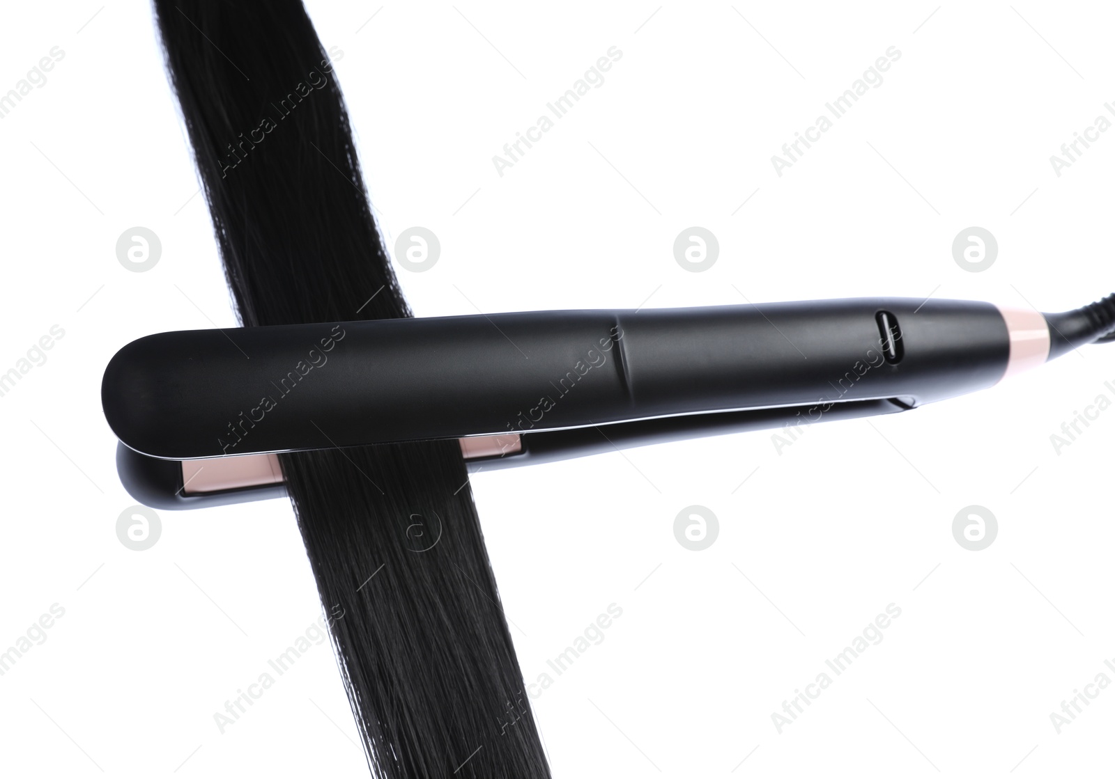 Photo of Straightener with black hair lock isolated on white