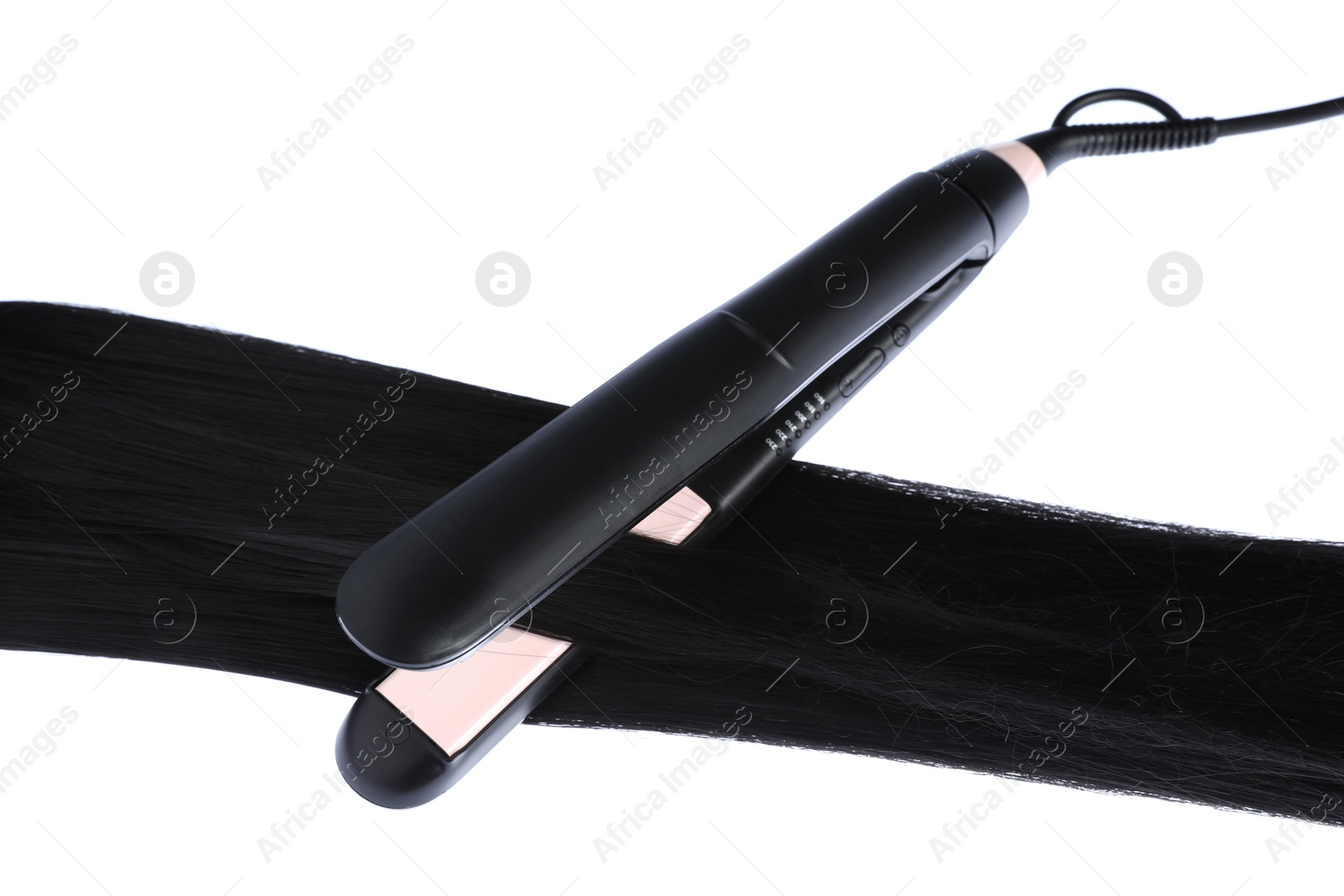 Photo of Straightener with black hair lock isolated on white