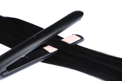 Photo of Straightener with black hair lock isolated on white