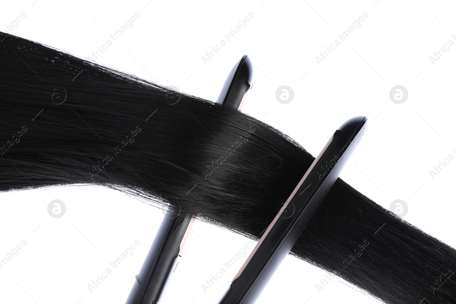 Photo of Straightener with black hair lock isolated on white