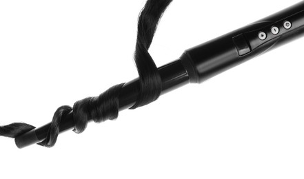 Photo of Curling iron with black hair lock isolated on white