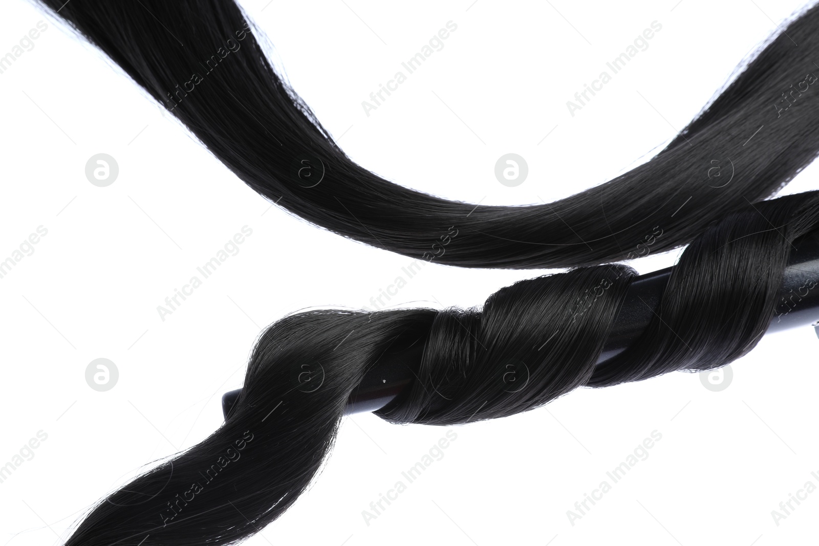 Photo of Curling iron with black hair lock isolated on white