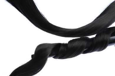 Photo of Curling iron with black hair lock isolated on white