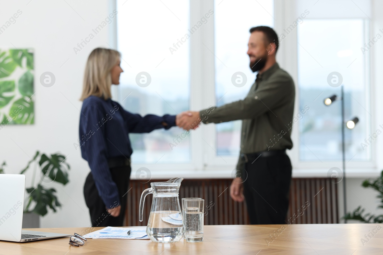 Business partners shaking hands in office, selective focus Photo of Business partners shaking hands in office, selective focus