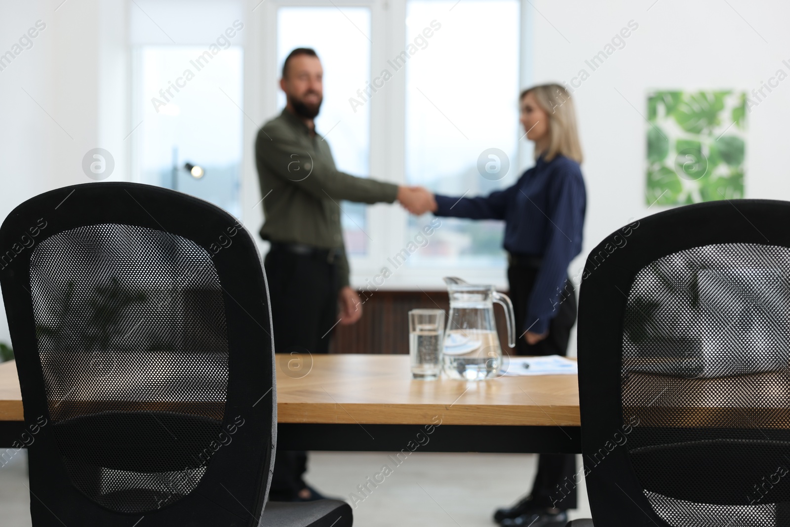 Photo of Business partners shaking hands in office, selective focus