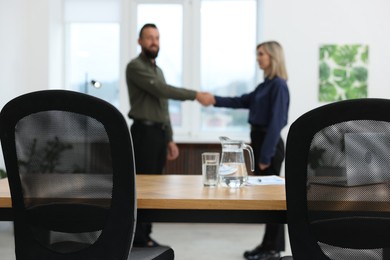 Photo of Business partners shaking hands in office, selective focus