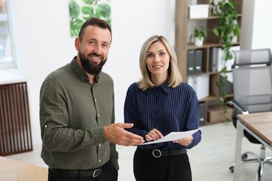Photo of Portrait of smiling business partners working together in office