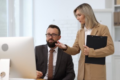Photo of Business partners working with computer in office