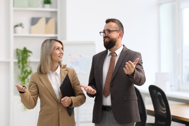 Photo of Business partners talking during meeting in office