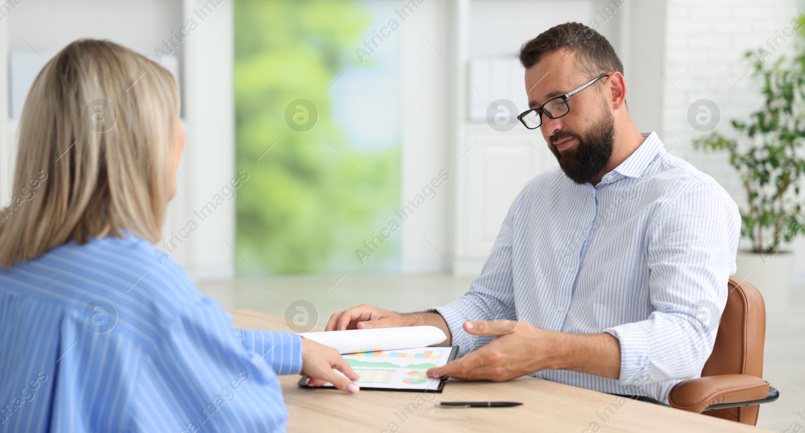 Business partners working with documents in office Photo of Business partners working with documents in office