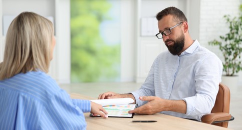 Photo of Business partners working with documents in office