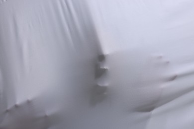 Photo of Silhouette of creepy ghost behind white sheet