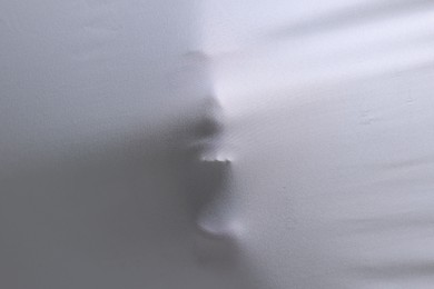 Photo of Silhouette of creepy ghost behind white sheet