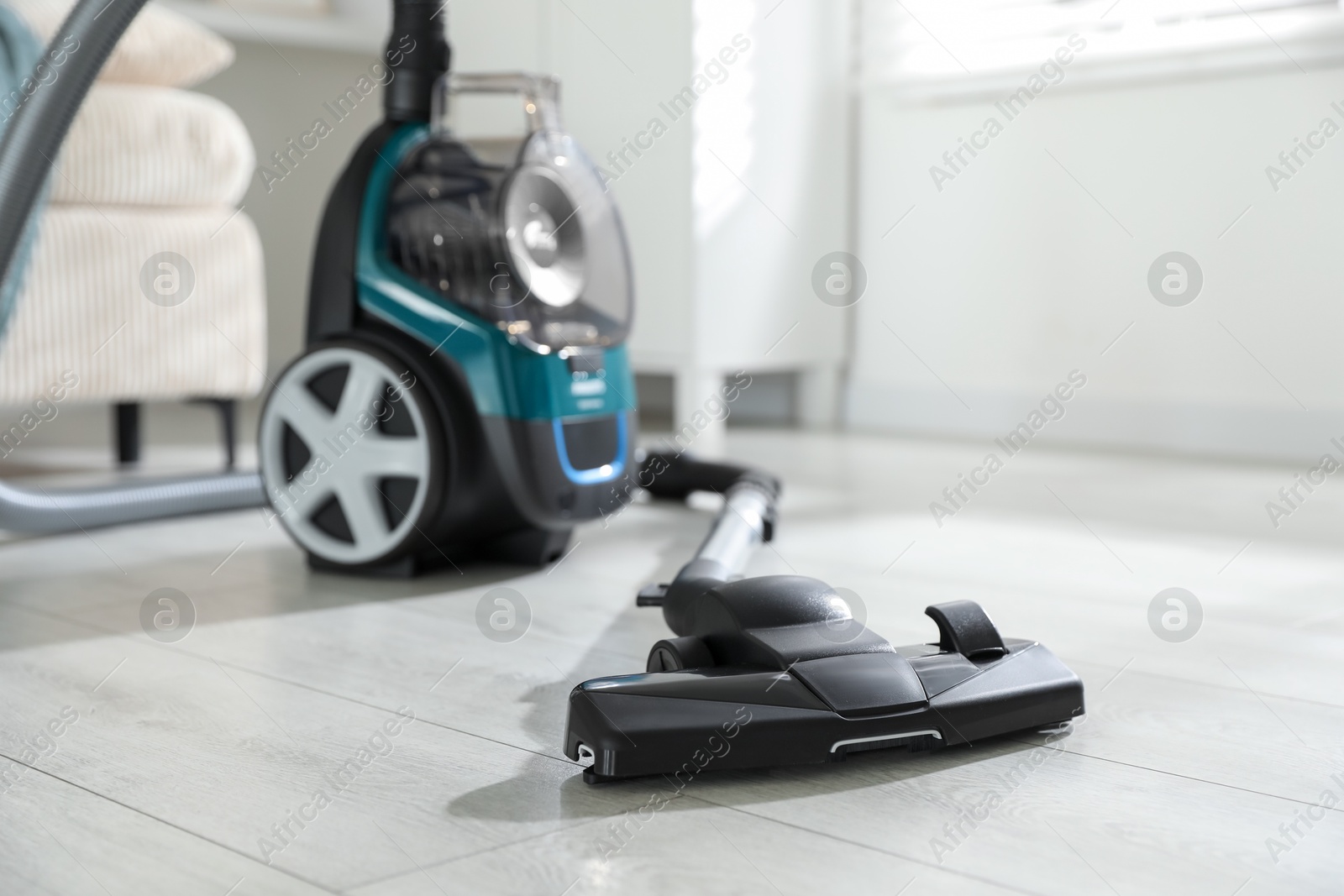 One vacuum cleaner on floor indoors. Household appliance Photo of One vacuum cleaner on floor indoors. Household appliance