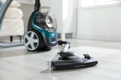 Photo of One vacuum cleaner on floor indoors. Household appliance