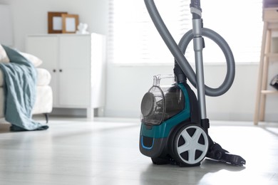 Photo of One vacuum cleaner on floor indoors. Space for text