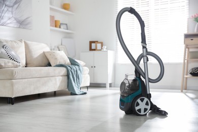 Photo of One vacuum cleaner on floor indoors. Household appliance