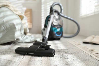 Photo of One vacuum cleaner on floor indoors, closeup