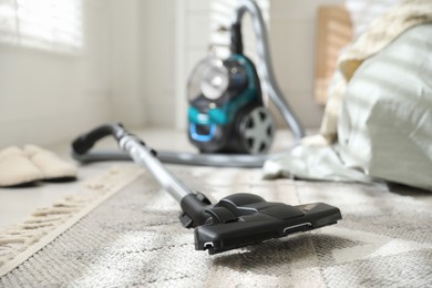 Photo of One vacuum cleaner on floor indoors, closeup