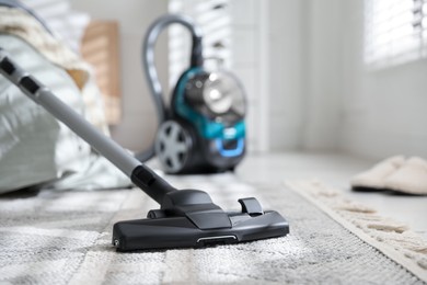 Photo of One vacuum cleaner on floor indoors, closeup