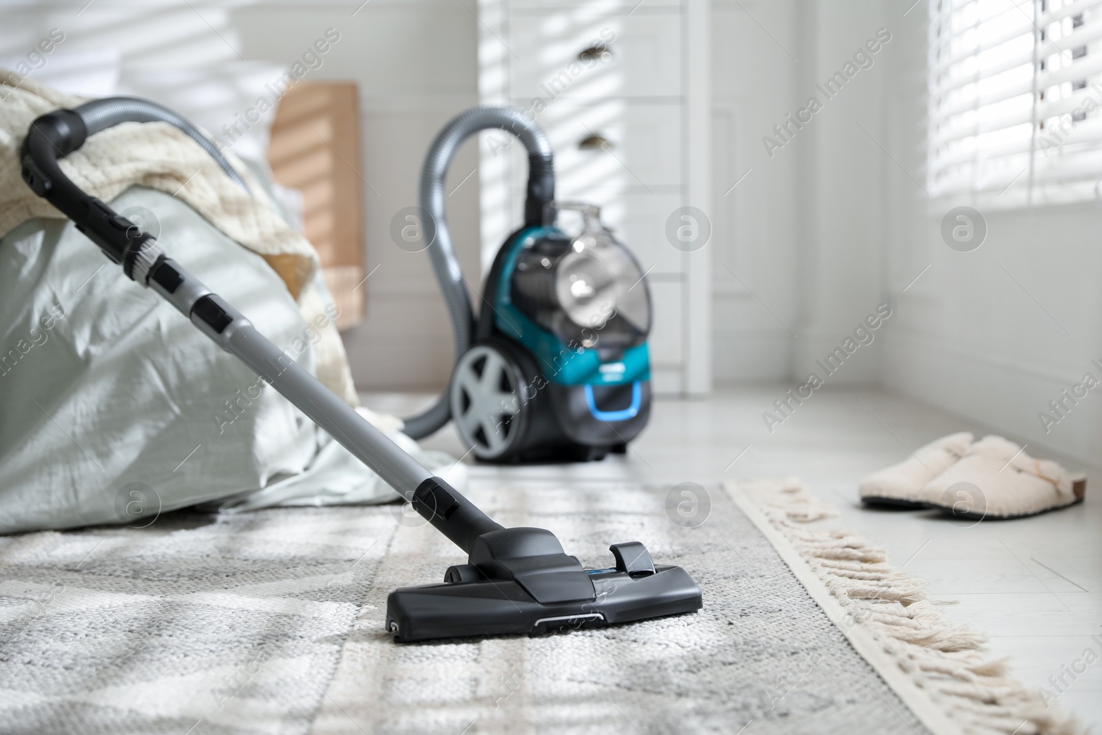 One vacuum cleaner on floor in bedroom Photo of One vacuum cleaner on floor in bedroom