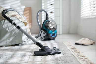 Photo of One vacuum cleaner on floor in bedroom