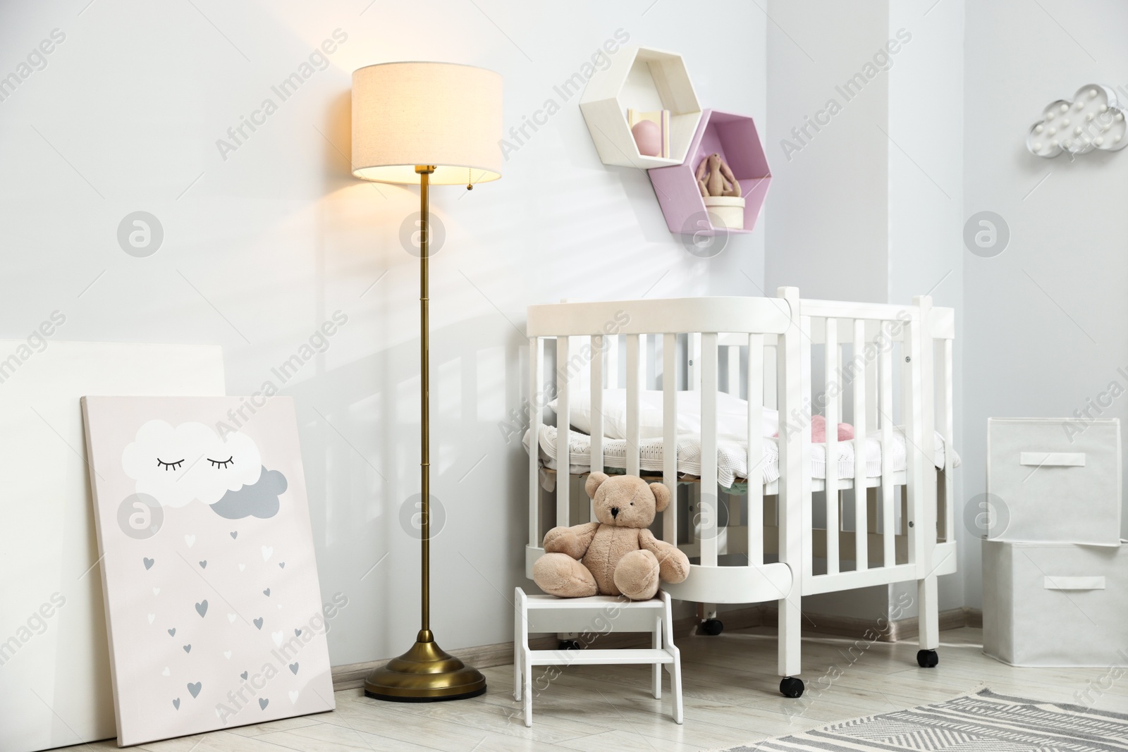 Cozy baby room interior with comfortable crib, toys and lamp Photo of Cozy baby room interior with comfortable crib, toys and lamp