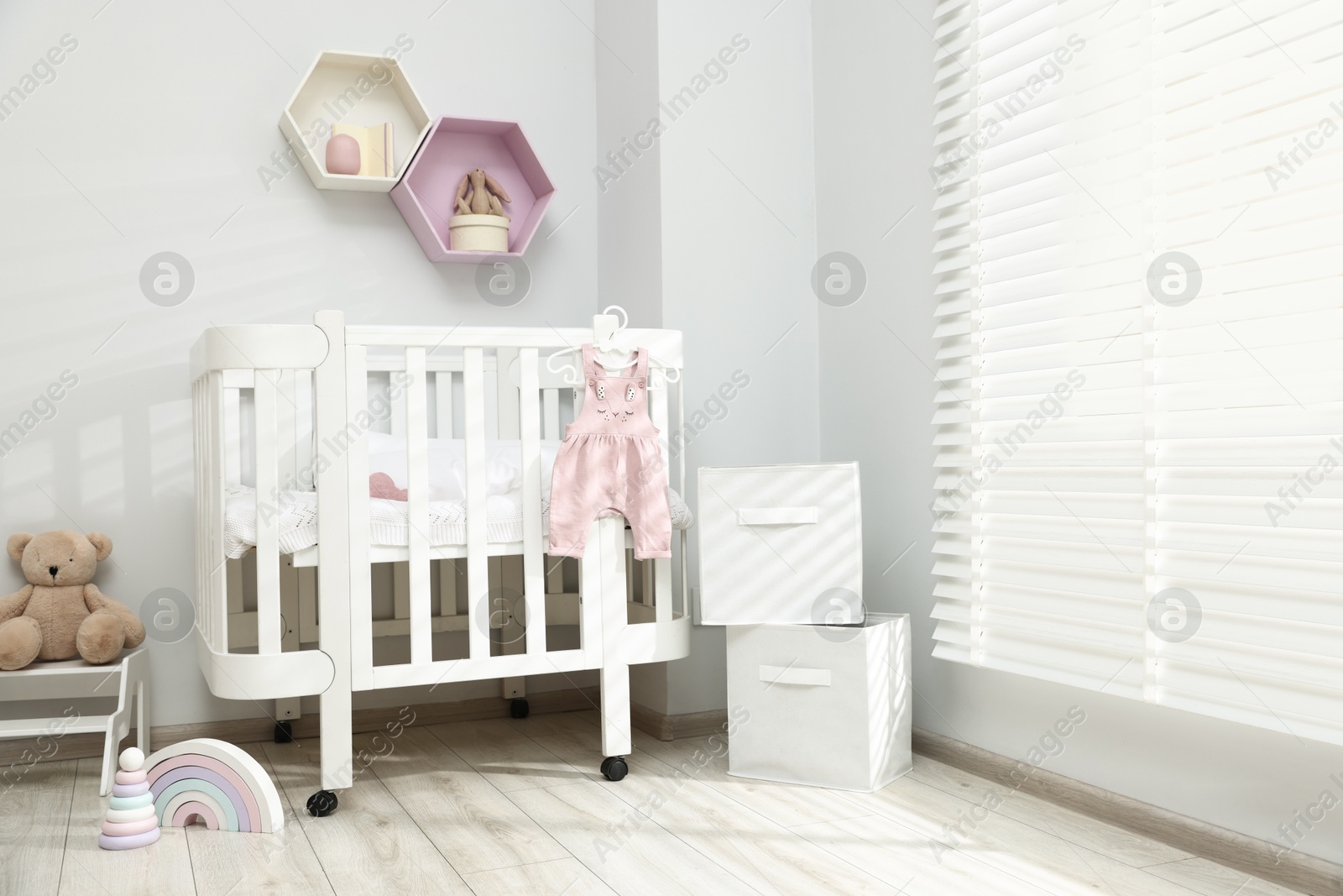 Stylish baby room interior with comfortable crib and other furniture Photo of Stylish baby room interior with comfortable crib and other furniture
