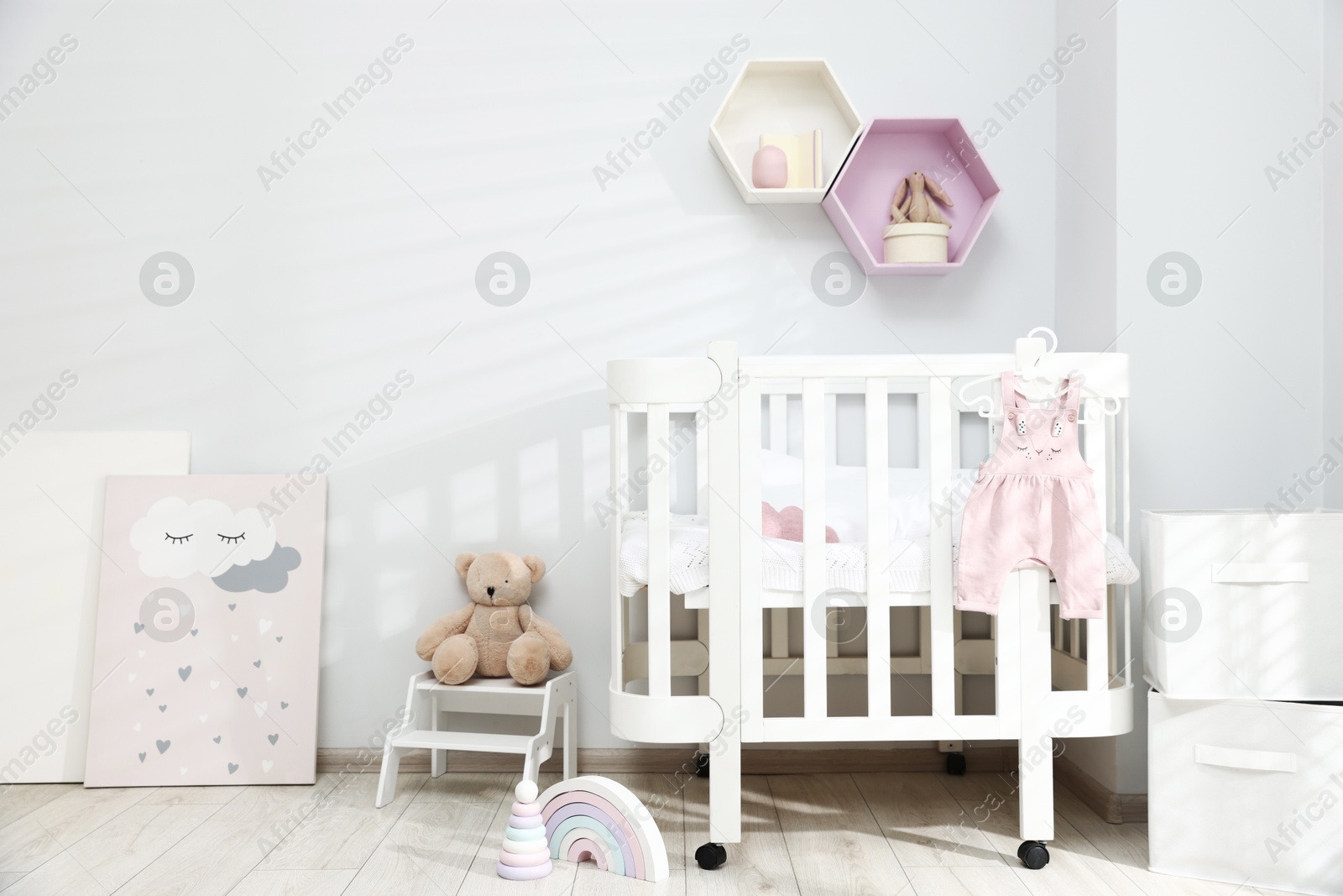 Stylish baby room interior with comfortable crib and other furniture Photo of Stylish baby room interior with comfortable crib and other furniture